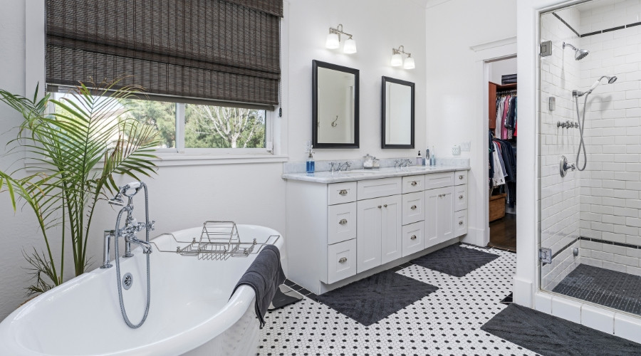Modern bathroom featuring a freestanding tub, dual sinks with mirrors, and a walk-in shower, emphasizing stylish design and functionality for a bathroom renovation.